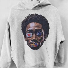 a gray sweatshirt with an image of a man's face painted on the front