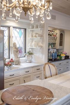 a chandelier hanging from the ceiling in a kitchen