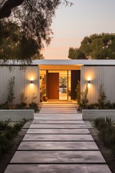 the entrance to a modern home at dusk