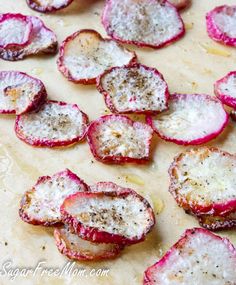 sliced up radishes on a baking sheet ready to be cooked in the oven