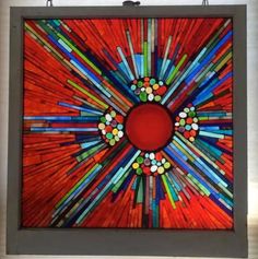 a colorful stained glass artwork hanging on the wall