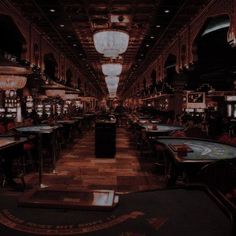 a casino room filled with lots of tables and chairs