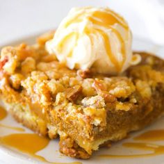 a close up of a bowl of food with ice cream on top and nuts in the middle