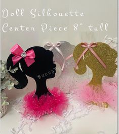 two silhouettes with pink and gold hair bows on them, one is wearing a headband