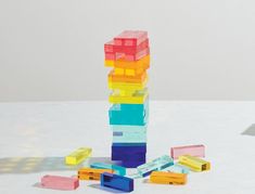 a stack of colorful blocks sitting on top of a white table