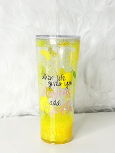 a yellow tumbler cup with the words, when life gives you lemons add