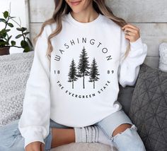 Introducing our "Washington" Sweatshirt, the perfect gift for anyone who loves the Evergreen State! This cozy sweater is designed for adventure, featuring a scenic mountain print that captures the essence of Washington's rugged beauty. Whether you're hitting the trails for a hike or simply cozying up at home, this sweatshirt is sure to keep you warm and stylish. Made from high-quality materials, it's built to last through all your outdoor adventures. Show off your love for Washington and the Pac Montana Sweatshirt, Travel Sweater, Evergreen State, Mountain Print, Green Mountain, Cozy Sweater, Rocky Mountain, Cozy Sweaters, Pacific Northwest