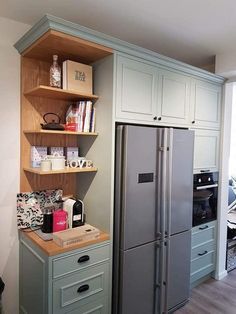 a kitchen with a refrigerator and some shelves