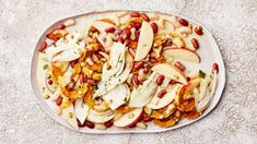 a white plate topped with sliced apples and beans