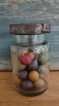 a glass jar filled with lots of different colored rocks