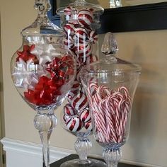 a large glass bowl filled with candy canes on top of a counter