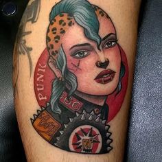 a woman's face with tattoos on her leg