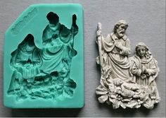 two molds depicting jesus, mary and baby jesus on a gray surface next to each other