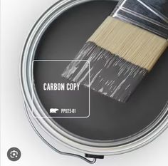 a paint can with a brush in it and the words carbon copy on top of it