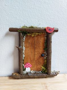 a small wooden door with mushrooms and birds on it