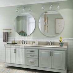 a bathroom with double sinks and two mirrors