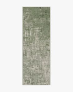 a green rug with some white and grey paint on it's edges, in front of a white background