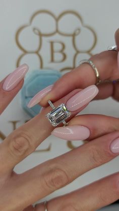 two hands with pink manies and an engagement ring