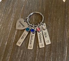 a keychain with four different charms on it that says, who doesn't love