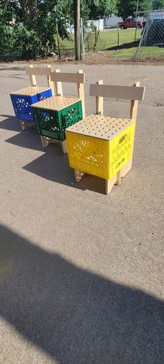 four wooden benches sitting in the middle of a parking lot