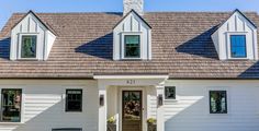 a white house with black shutters and windows