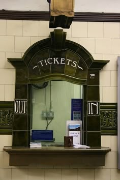 there is a mirror on the wall in the bathroom that says ticket's out