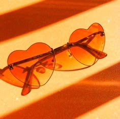 a pair of heart shaped sunglasses sitting on top of a table