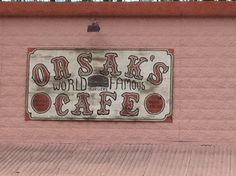 a sign on the side of a building that says orsak's world famous cafe