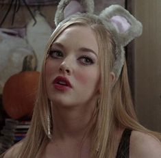 a woman with long blonde hair wearing bunny ears