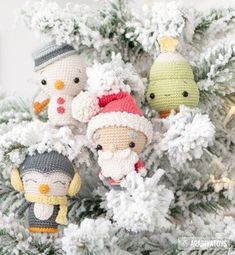 crocheted christmas ornaments are hanging on a white tree with snowflakes and pine cones