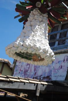 there is a bell made out of marshmallows hanging from the side of a building