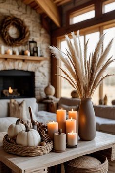 a living room filled with lots of furniture and candles on top of a wooden table