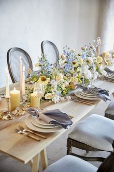 a table set with flowers and candles for a formal dinner or special occasion in the dining room