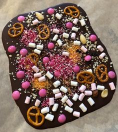 a chocolate tray with pretzels, marshmallows, and pretzels on it