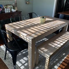 a wooden table and two chairs in a room