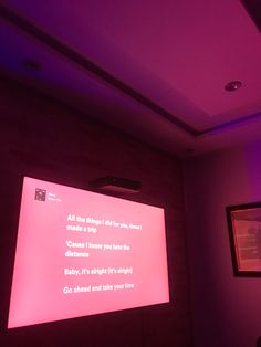 a projection screen in a room with purple lighting