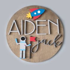 a wooden sign that says,'aden dad'with an astronaut on it