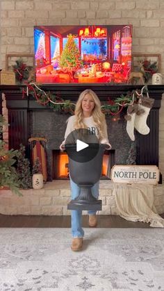 a woman standing in front of a christmas fireplace