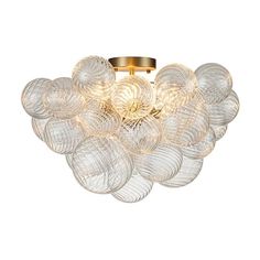 a flush light fixture with glass balls on the bottom and gold trimming around it