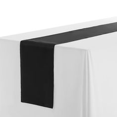 a black and white table runner on top of a bed