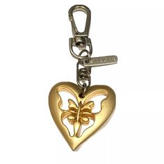 a heart shaped key chain with a butterfly on it