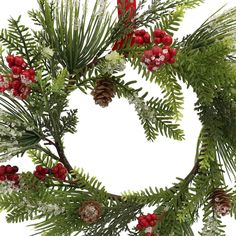 a christmas wreath with red berries and pine cones