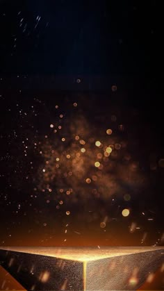 fireworks are lit up in the night sky above a golden pyramid on a black background