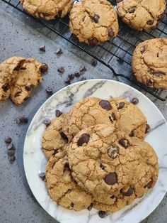 chocolate chip cookies on a plate next to cooling rack