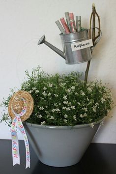 a potted plant with some gardening tools in it