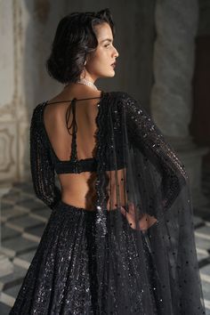 This lehenga set features black sequin embroidery on a dark nude base. It is paired with a full sleeves blouse and matching scalloped dupatta.From Seema Gujral's Inara collection. DELIVERY TIMEPlease allow 8-12 weeks for your outfit to arrive. FABRIC DETAILSNet Professional cleaning only. Black Sequin Lehenga, Blouses Designs Latest, Scalloped Dupatta, Full Sleeves Blouse, Sequin Lehenga, Choli Blouse Design, Glitter Prom Dress, Seema Gujral, Reception Outfit