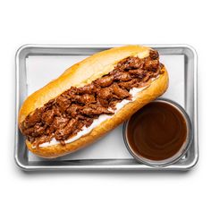 a sandwich with meat and sauce on a tray