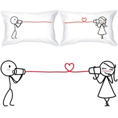 two pillows with stick figures drawn on them and one is holding a megaphone to someone's head