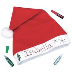 a red and white santa hat with writing on it, surrounded by other holiday items