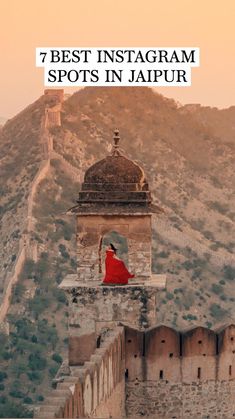 a person sitting on top of a stone wall